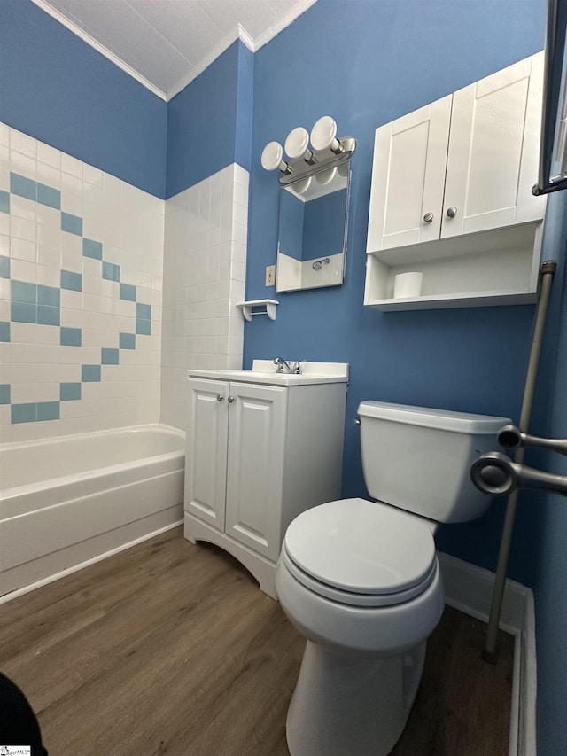 full bathroom featuring tub / shower combination, ornamental molding, vanity, hardwood / wood-style flooring, and toilet