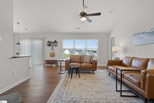 living room featuring ceiling fan, dark hardwood / wood-style flooring, and vaulted ceiling