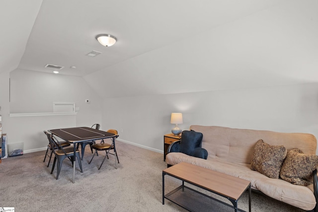 carpeted dining area featuring lofted ceiling