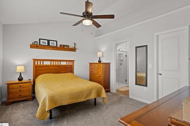 carpeted bedroom with ceiling fan, lofted ceiling, and ensuite bath