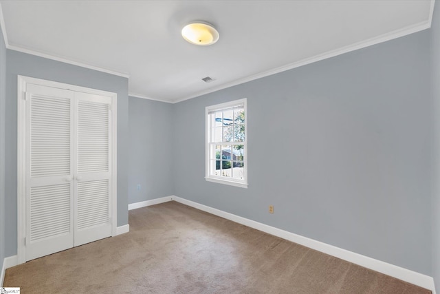 unfurnished bedroom with light carpet, a closet, and ornamental molding