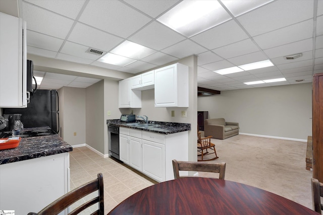 kitchen with white cabinetry, dishwasher, sink, a paneled ceiling, and light carpet