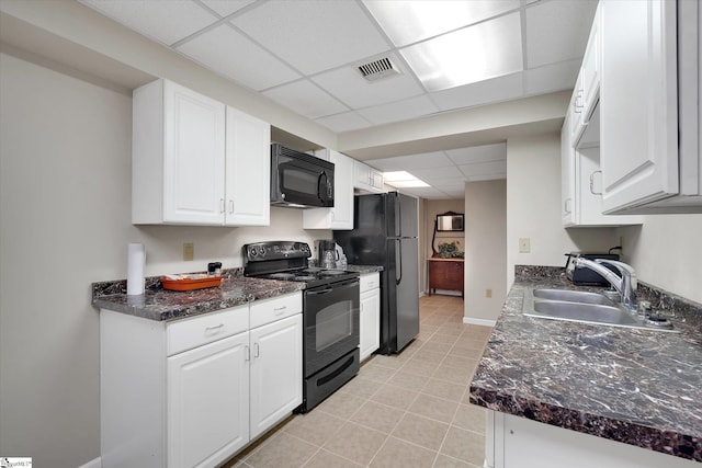 kitchen featuring white cabinets, sink, a drop ceiling, and black appliances