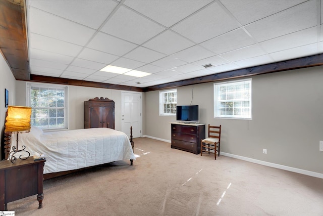 carpeted bedroom featuring a paneled ceiling