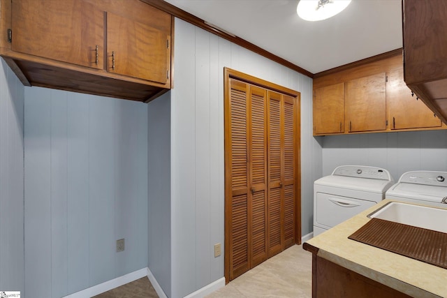 laundry room featuring wood walls, cabinets, separate washer and dryer, ornamental molding, and light tile patterned floors