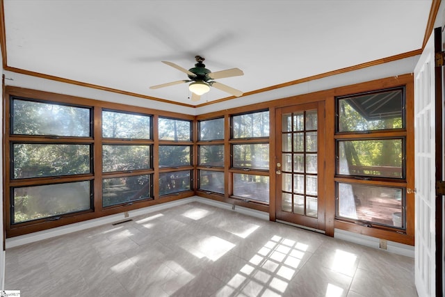 unfurnished sunroom with ceiling fan