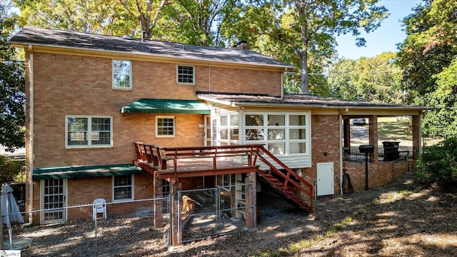 rear view of property with a wooden deck