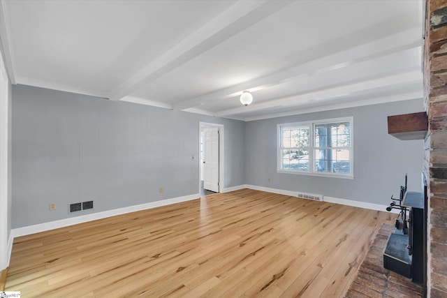 living room with beam ceiling and light wood-type flooring