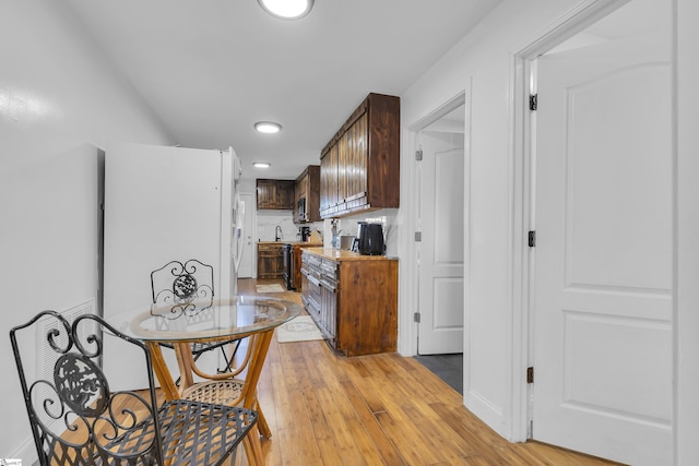 kitchen with tasteful backsplash and light hardwood / wood-style flooring