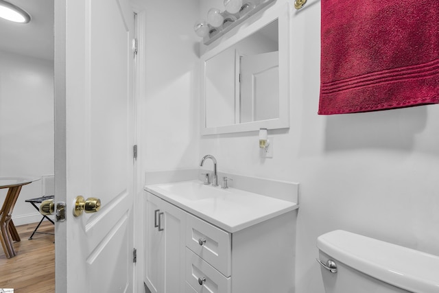 bathroom featuring vanity, toilet, and wood-type flooring