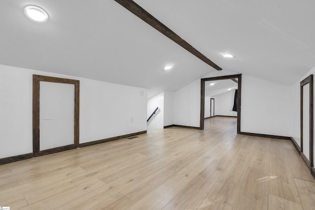 bonus room featuring vaulted ceiling with beams and light hardwood / wood-style floors