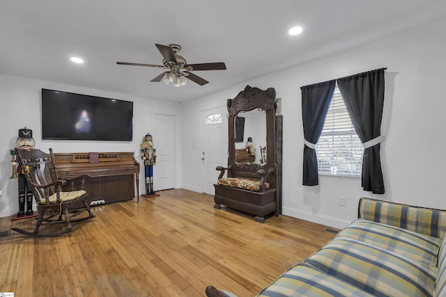 living room with hardwood / wood-style flooring and ceiling fan