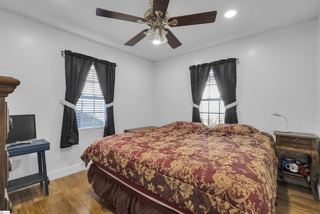 bedroom with ceiling fan and hardwood / wood-style floors