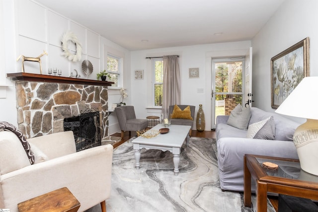 living room with a fireplace and wood-type flooring