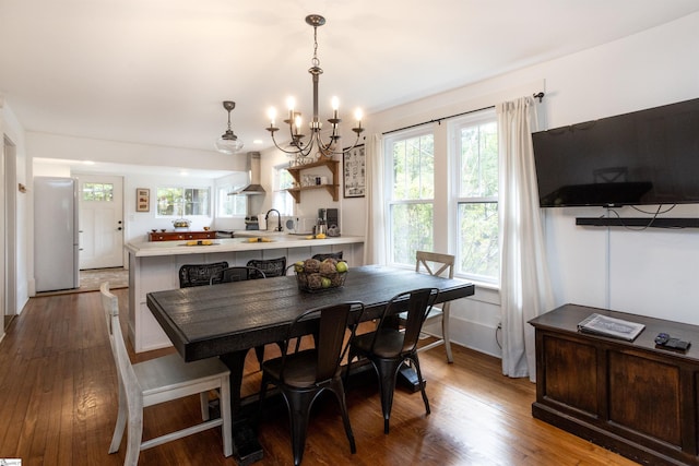 dining space with dark hardwood / wood-style floors and a chandelier