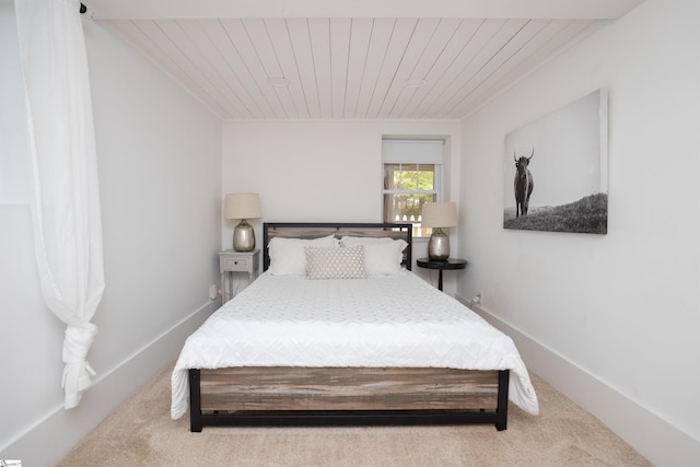 bedroom featuring carpet floors and wood ceiling