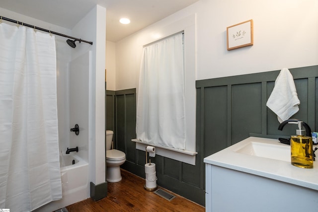 full bathroom with hardwood / wood-style floors, shower / bath combination with curtain, toilet, and vanity