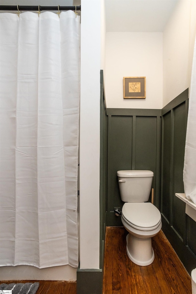 bathroom featuring wood-type flooring and toilet