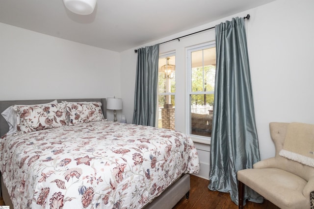 bedroom with dark hardwood / wood-style floors