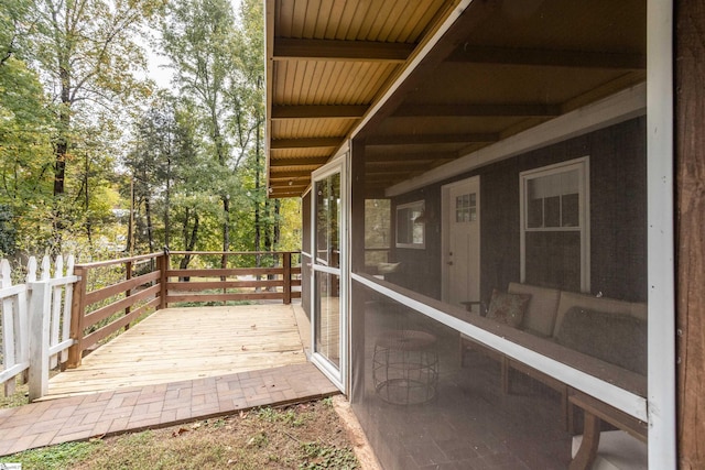 wooden deck with a sunroom