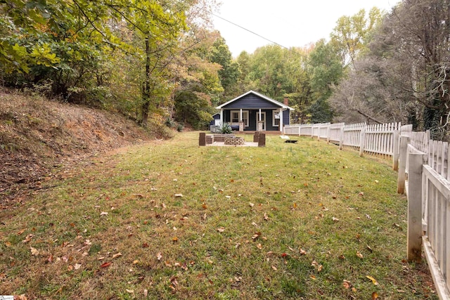 view of yard featuring an outdoor fire pit