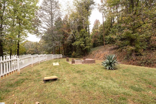 view of yard with a fire pit