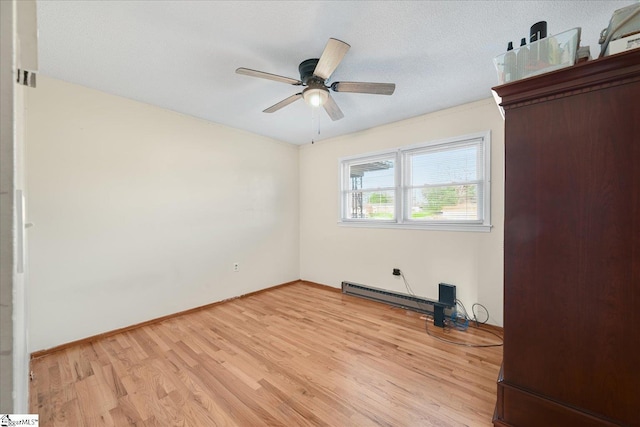 unfurnished room featuring ceiling fan, light hardwood / wood-style floors, a textured ceiling, and a baseboard radiator