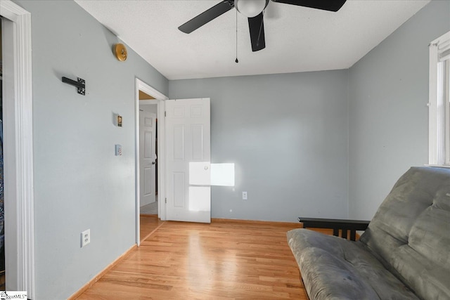 sitting room featuring light wood-type flooring and ceiling fan