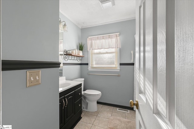 bathroom with vanity, tile patterned flooring, toilet, ornamental molding, and a textured ceiling