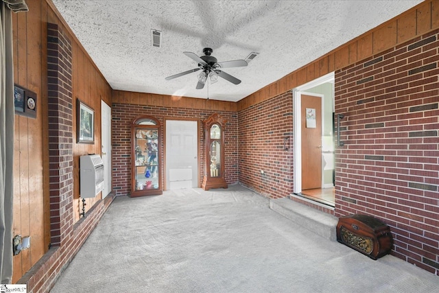 interior space featuring ceiling fan and heating unit