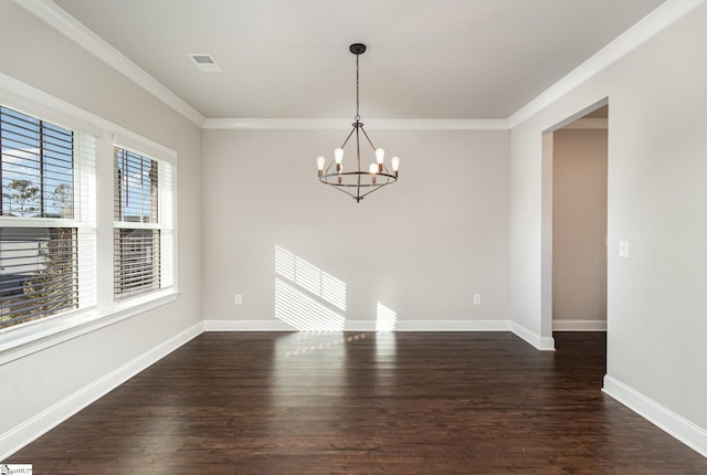 spare room with a chandelier, dark hardwood / wood-style floors, and ornamental molding