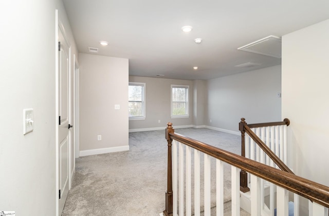 corridor with light colored carpet