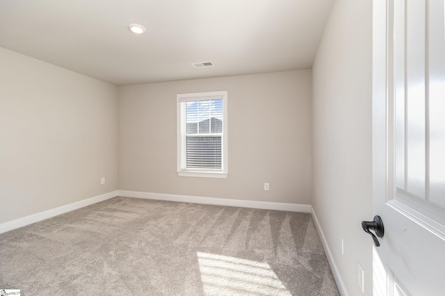 unfurnished room with light carpet