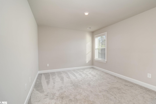 unfurnished room featuring light colored carpet