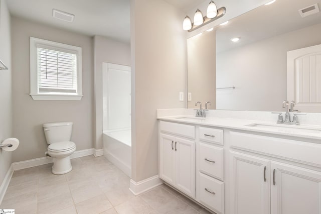 bathroom featuring tile patterned flooring, vanity, and toilet