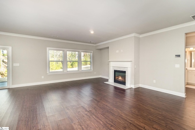 unfurnished living room featuring a premium fireplace, dark wood-type flooring, and ornamental molding