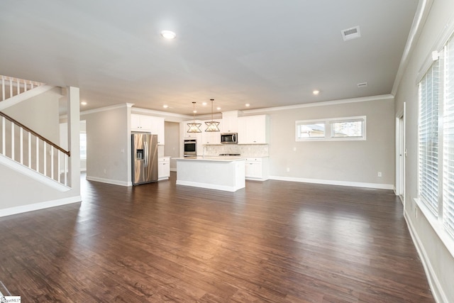 unfurnished living room with sink, ornamental molding, and dark wood-type flooring