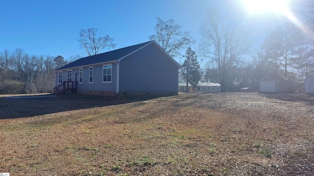 view of home's exterior with a yard, an outdoor structure, and a garage