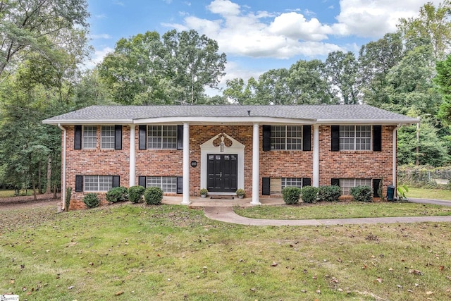 split foyer home with a front lawn