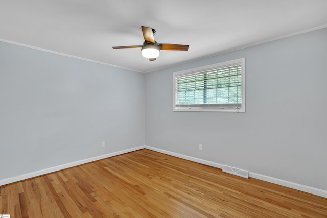 empty room featuring ceiling fan, crown molding, and light hardwood / wood-style floors