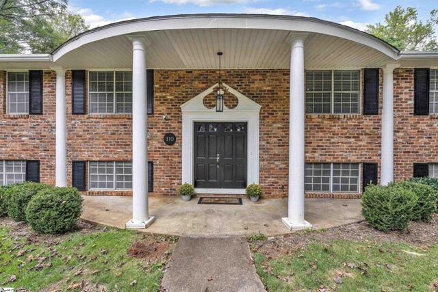 doorway to property featuring covered porch