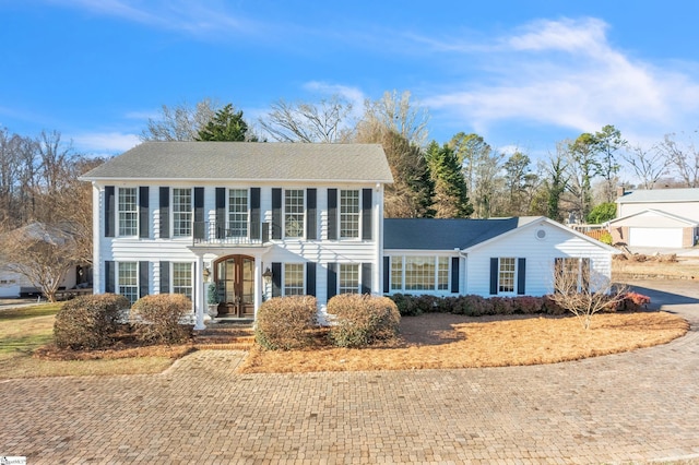 colonial-style house featuring covered porch