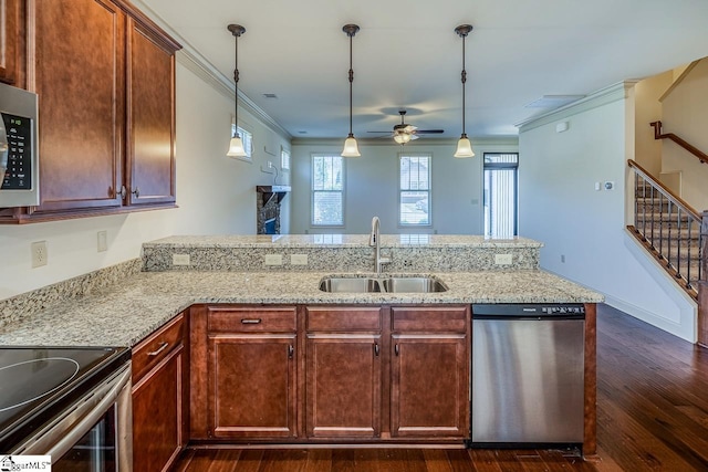 kitchen with kitchen peninsula, appliances with stainless steel finishes, ceiling fan, sink, and pendant lighting