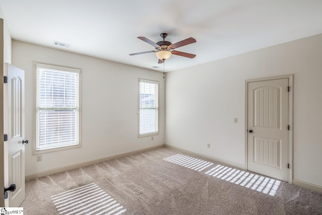 carpeted empty room with ceiling fan