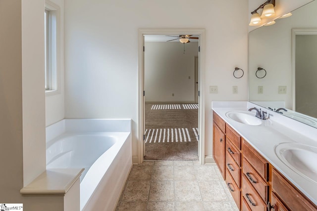 bathroom featuring a tub, ceiling fan, and vanity