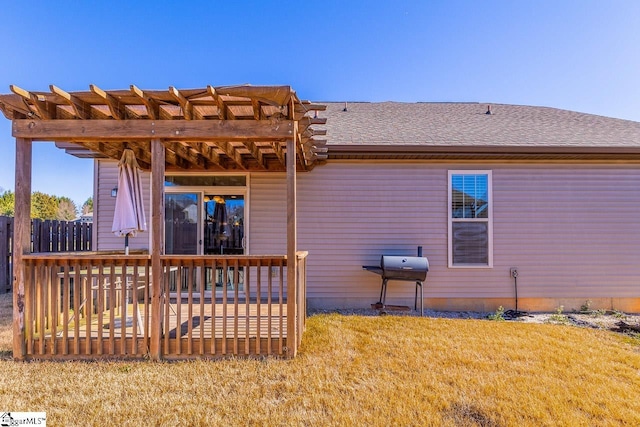 back of house with a lawn, a pergola, and a wooden deck