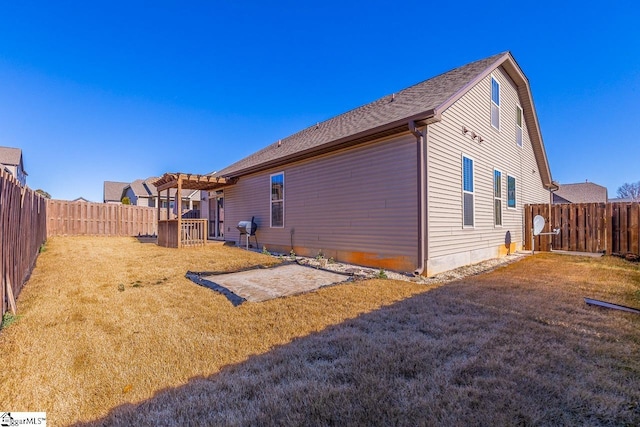 back of property featuring a lawn and a pergola