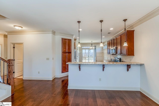 kitchen with kitchen peninsula, appliances with stainless steel finishes, light stone countertops, a kitchen breakfast bar, and hanging light fixtures