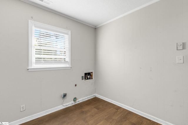 clothes washing area with washer hookup, hookup for a gas dryer, dark hardwood / wood-style flooring, crown molding, and a textured ceiling