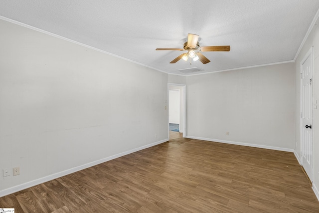 empty room featuring hardwood / wood-style flooring, ceiling fan, ornamental molding, and a textured ceiling